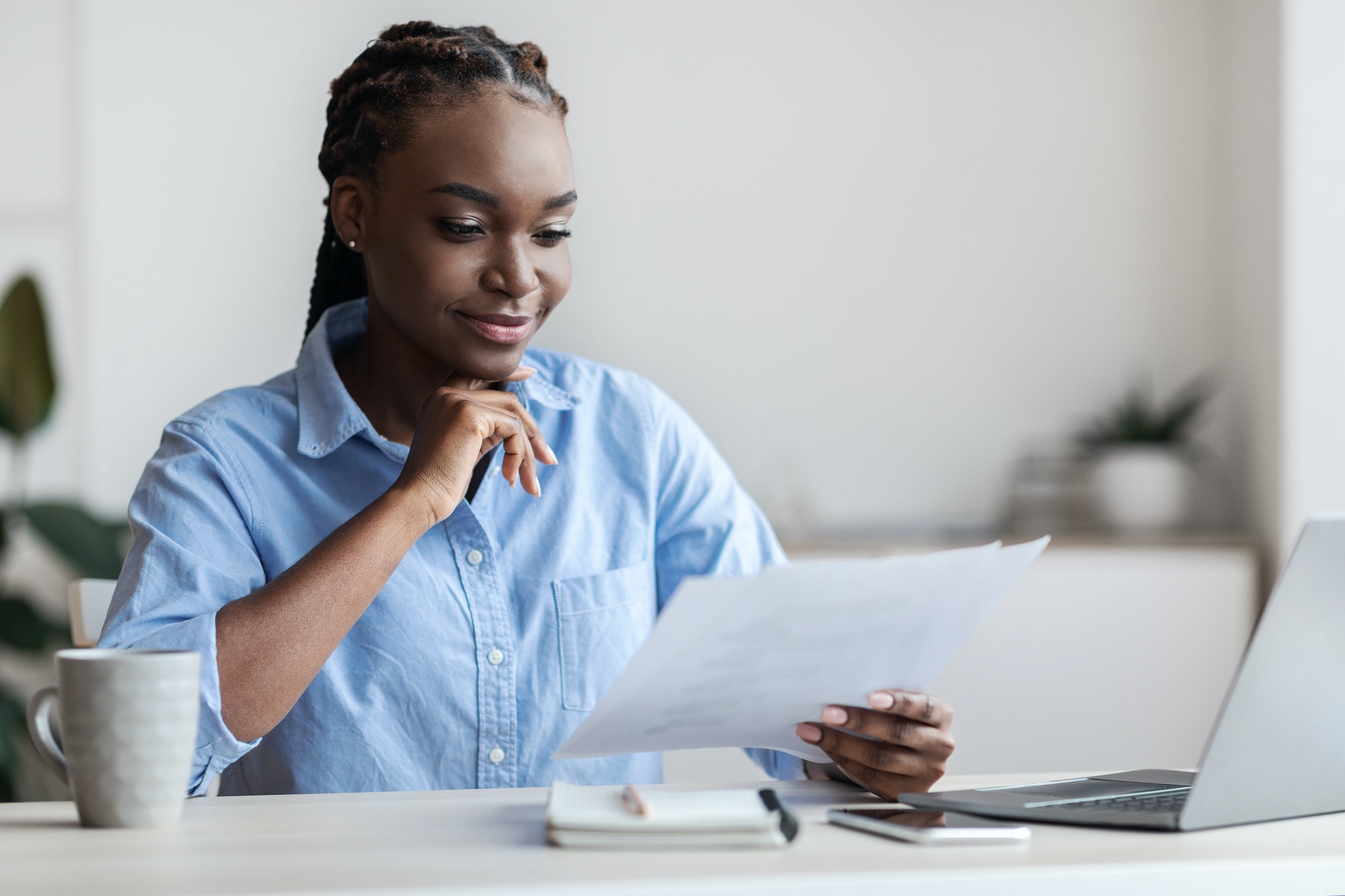 Ambitious Black Female Entrepreneur Working With Business Documentation In Office